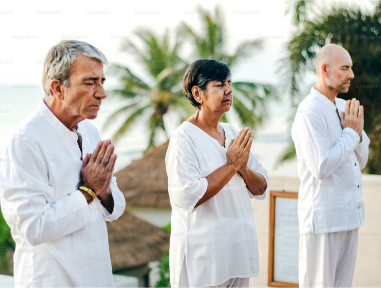 Three people standing in prayer
